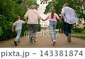 Parents, children son daughter run through city park. Family in park. Father mother, children son daughter joyfully running city street. Kids playing. Happy family. Happy people. Dad mom kids holidays 143381874