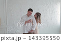 Lovers bask in the light room of the photo studio. 143395550