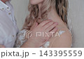 Lovers hug against the wall in the room. 143395559