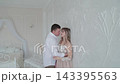 Lovers hug against the wall in the room. 143395563