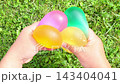 ASMR Colorful Water Balloons Cupped Together by Two Hands 143404041