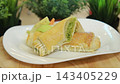 Baked puff pastry rolls with green pea filling served with vegetables 143405229