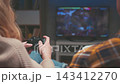 Closeup of Unrecognizable Man Holding White Gamepad during Video Game Session. Male Hand Use Controller while Woman Sits Next with Black Device. Couples Home Leisure and Electronic Technology 4k 143412270