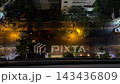 Night Traffic Moves Along a Tree Lined City Street 143436809