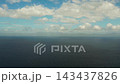 Sea surface with waves against the blue sky with clouds, aerial view. Water cloud horizon background. Blue sea water with small waves against sky. 143437826
