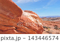 Slow camera movement revealing stunning red sandstone formations and arid desert landscape of valley of fire state park in nevada on bright, sunny day with blue skies overhead 143446574