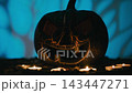 scary halloween pumpkin lies on the ground in the night 143447271