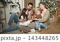 Merry Christmas Xmas. Happy family mother father two children playing near Christmas tree at home. Parents kids celebrating Christmas New Year enjoying winter holidays together. Family moments at home 143448265