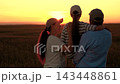 Dad mom, kid daughter happily embracing, sky, sunset. Happy family travel outdoors. Loving parents with child, field, sun. People envisioning happy future. Dad mom, child girl. Children parents nature 143448861
