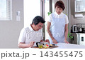 A senior man being served meals at a nursing home and a senior female staff member. 143455475