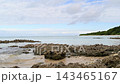 干潮時に現れる琉球石灰岩の岩場と穏やかな海（沖縄の海岸風景・手つかずの自然） 143465167