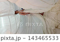 Woman in flowing white fabric 143465533