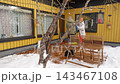 Happy winter lifestyle moment as a couple clears fresh snow from a cozy home patio. Cold weather, soft daylight, teamwork and seasonal mood create a warm family atmosphere. 143467108