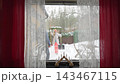 Happy winter lifestyle moment as a couple clears fresh snow from a cozy home patio. Cold weather, soft daylight, teamwork and seasonal mood create a warm family atmosphere. 143467115