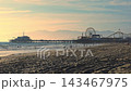 USA, March 26, 2026, Santa Monica, California, Visitors gather on Santa Monica beach as its famous pier and amusement rides extend into the Pacific Ocean, Evening sunlight silhouettes families near 143467975