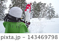 Grandmother pulling child on sled in snowy Finland, enjoying winter family lifestyle outdoors. Warm clothing, joy, love, and seasonal holiday atmosphere in bright daylight. 143469798