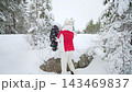 Winter walk in snowy forest. Family lifestyle moment with child and adult holding hands, warm clothing, holiday mood, peaceful nature, love and togetherness outdoors. 143469837