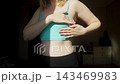 Woman performing breast self examination and checking armpit for lumps. Preventive healthcare routine for early cancer detection and personal wellness. 143469983