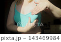 Woman performing breast self examination and checking armpit for lumps. Preventive healthcare routine for early cancer detection and personal wellness. 143469984