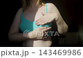 Woman performing breast self examination and checking armpit for lumps. Preventive healthcare routine for early cancer detection and personal wellness. 143469986