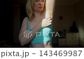 Woman performing breast self examination and checking armpit for lumps. Preventive healthcare routine for early cancer detection and personal wellness. 143469987