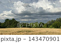 Dramatic sky clouds over field. 143470901