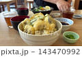 A hearty meal of eel tempura rice bowl, seafood rice bowl, and miso soup. 143470992