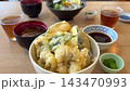 A hearty meal of eel tempura rice bowl, seafood rice bowl, and miso soup. 143470993
