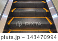 The escalator steps are easily recognizable by their yellow trim. 143470994