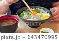 A seafood rice bowl with fresh whitebait, enjoyed by breaking the egg yolk with chopsticks, and miso soup. 143470995