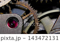 Macro shot of vintage mechanical watch movement with rotating rusty gears and ruby jewel bearing 143472131