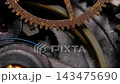 Extreme macro shot of vintage mechanical watch movement with rusty gears and oscillating balance spring 143475690
