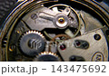 Macro shot of vintage mechanical watch movement with oscillating balance wheel and ruby jewel bearing 143475692
