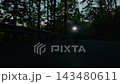 Dynamic tracking shot of a motorcyclist riding through a winding forest road, filmed from the front with fast camera movement, motion blur and a strong sense of speed and adventure. 143480611