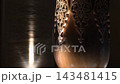Intricate Carved Patterns on Traditional Uzbek Wooden Columns at Night. 143481415
