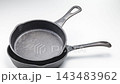 The stacked cast iron skillets used in the kitchen express the texture and quality of the cookware. 143483962