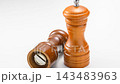 A wooden pepper mill placed against a white background, a cooking tool with its internal mechanism visible. 143483963