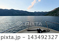 Motorboat sailing on Kotor Bay with picturesque mountains of Montenegro in the background 143492327