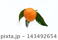 A video of a mandarin orange with leaves attached spinning against a white background; loopable. 143492654
