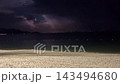 Night Beach Waves Beneath Distant Shore Lights 143494680