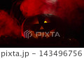 Jack o lantern suddenly bursts into flame and lights up in darkness with ominous red smoke. Halloween pumpkin lantern face flickers in frightening way 143496756