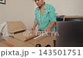 Talented woman sewing and creating patterns in her home workshop studio. 143501751