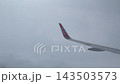 Airplane Wing Flying through Thick Gray Clouds over Thailand 143503573