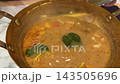 Serving Thai Tom Yum Soup with a Spoon 143505696