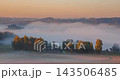 Hazy morning fog with slowly moving fog over the forest 143506485