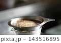 Close-up of coffee grounds and foam expanding during hand-drip brewing - Live 4K footage 143516895