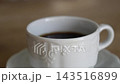 Black coffee in a white ceramic cup; close-up with shallow depth of field; live-action 4K. 143516899