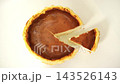 Fresh baked burnt basque cheesecake with a portion slice on a white background. Perfect for bakery ads, dessert menus, and food blogs. 143526143