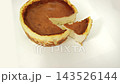 Fresh baked burnt basque cheesecake with a portion slice on a white background. Perfect for bakery ads, dessert menus, and food blogs. 143526144