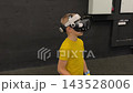 A boy in yellow Tshirt immerses himself in virtual reality. Playing virtual reality game with headset. A party children's center. Modern technology, VR games, and digital entertainment for children. 143528006